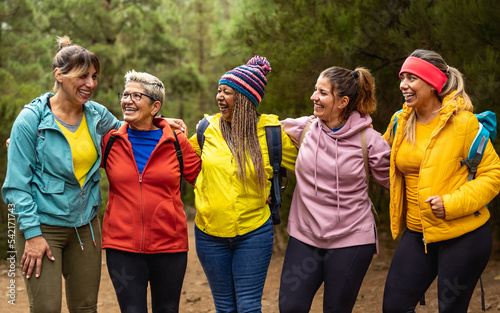Happy women with different ages and ethnicities having fun in the woods - Adventure and travel people concept