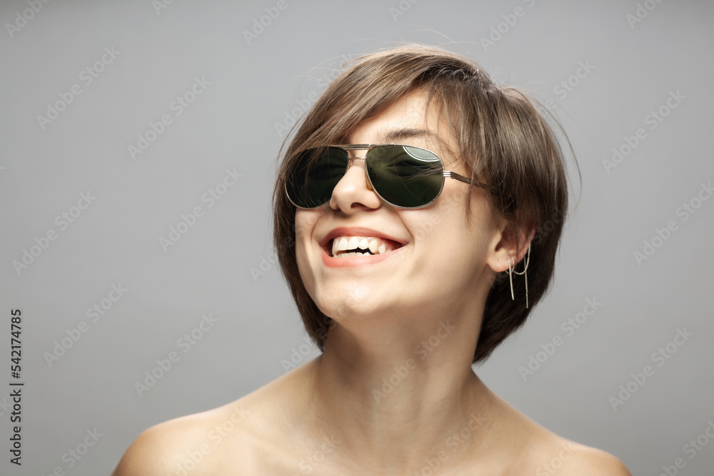 Beautiful girl fashion portrait wearing sunglasses. Happy smiling face expression. Beautiful girl fashion portrait wearing sunglasses. Happy smiling face expression.