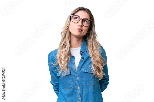Young Uruguayan woman over isolated background and looking up photo