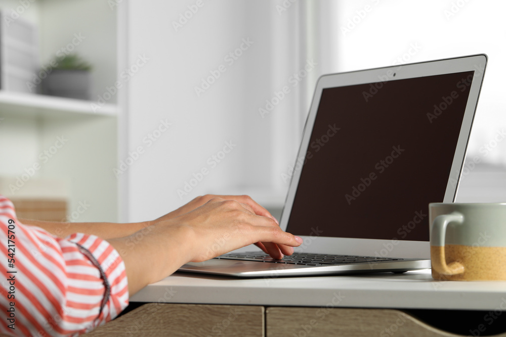 Young woman working with laptop at workplace in office, closeup Young woman working with laptop at workplace in office, closeup