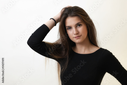 Portrait of serious beautiful girl on the light background. Horizontally. 