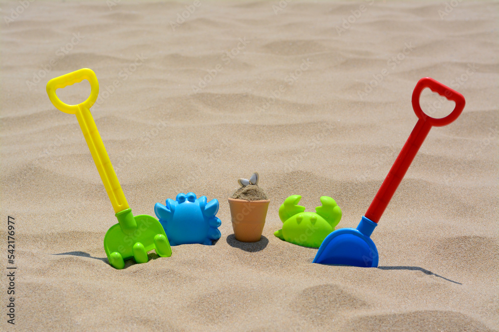 Set of colorful beach toys on sand Set of colorful beach toys on sand