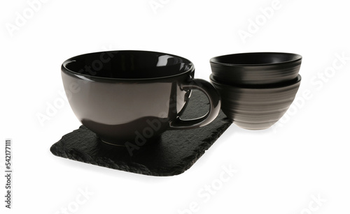 Set of black ceramic tableware with slate plate on white background