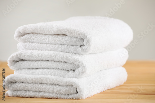 Stack of folded towels on wooden table