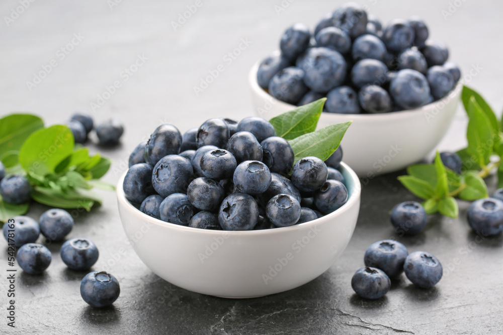 Tasty fresh blueberries on grey table, closeup Tasty fresh blueberries on grey table, closeup