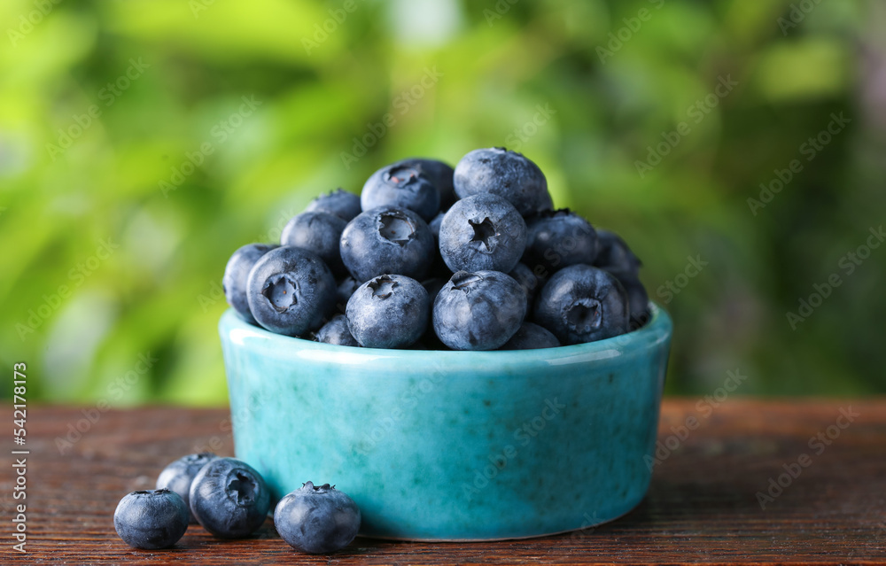 Tasty fresh blueberries on wooden table outdoors, closeup Tasty fresh blueberries on wooden table outdoors, closeup