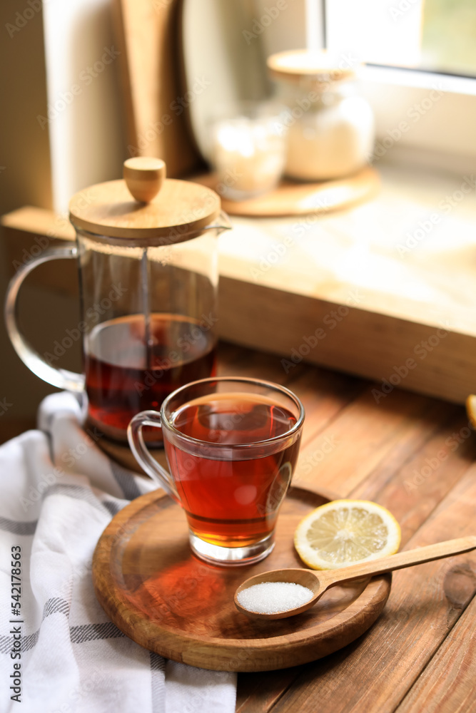 Delicious tea, sugar and lemon on wooden table Delicious tea, sugar and lemon on wooden table