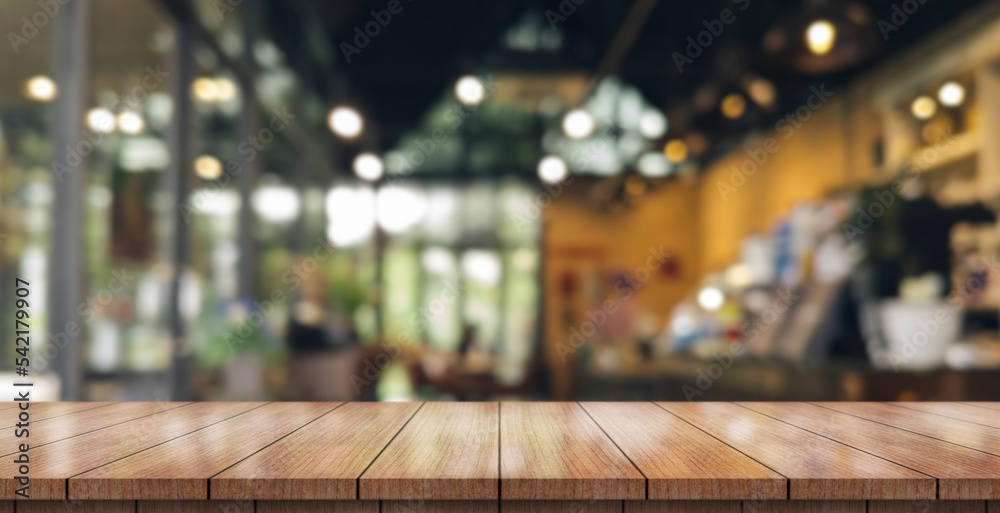 Empty wooden table top with lights bokeh on blur restaurant background. Empty wooden table top with lights bokeh on blur restaurant background.