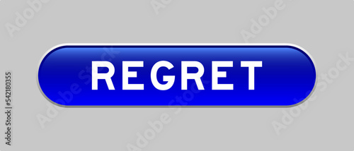 Blue color capsule shape button with word regret on gray background