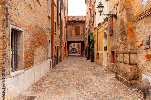 Fototapeta Naklejka Na Ścianę i Meble -  Historic streets of Ferrara, Italy. Narrow streets, historic building facades.