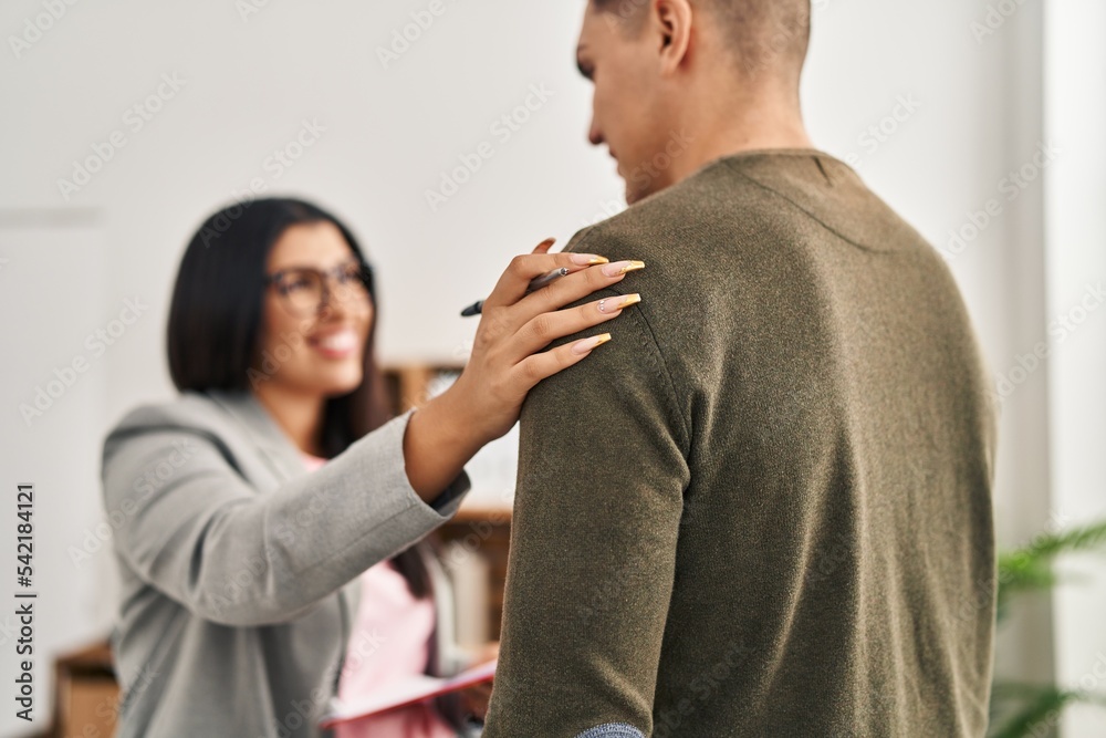 Man and woman having psychology session standing at clinic Man and woman having psychology session standing at clinic