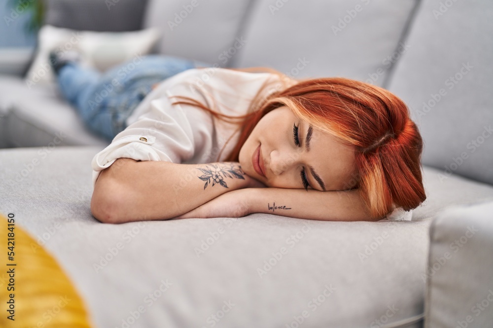 Young caucasian woman lying on sofa sleeping at home Young caucasian woman lying on sofa sleeping at home
