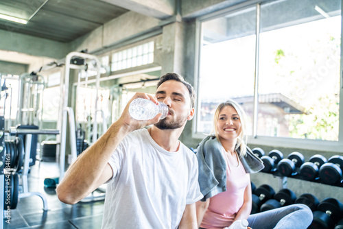 Happy couple drinkking water after exercise in sport fitness gym © themorningglory