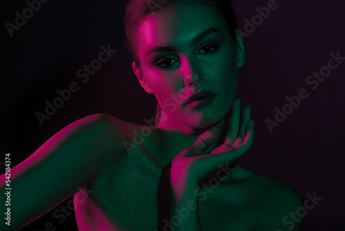 Woman on green pink neon background.