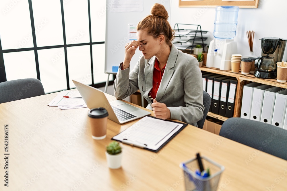 Young woman business worker stressed using laptop working at office Young woman business worker stressed using laptop working at office
