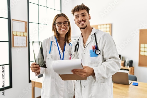 Two hispanic doctor working in a medical meeting at the clinic office.