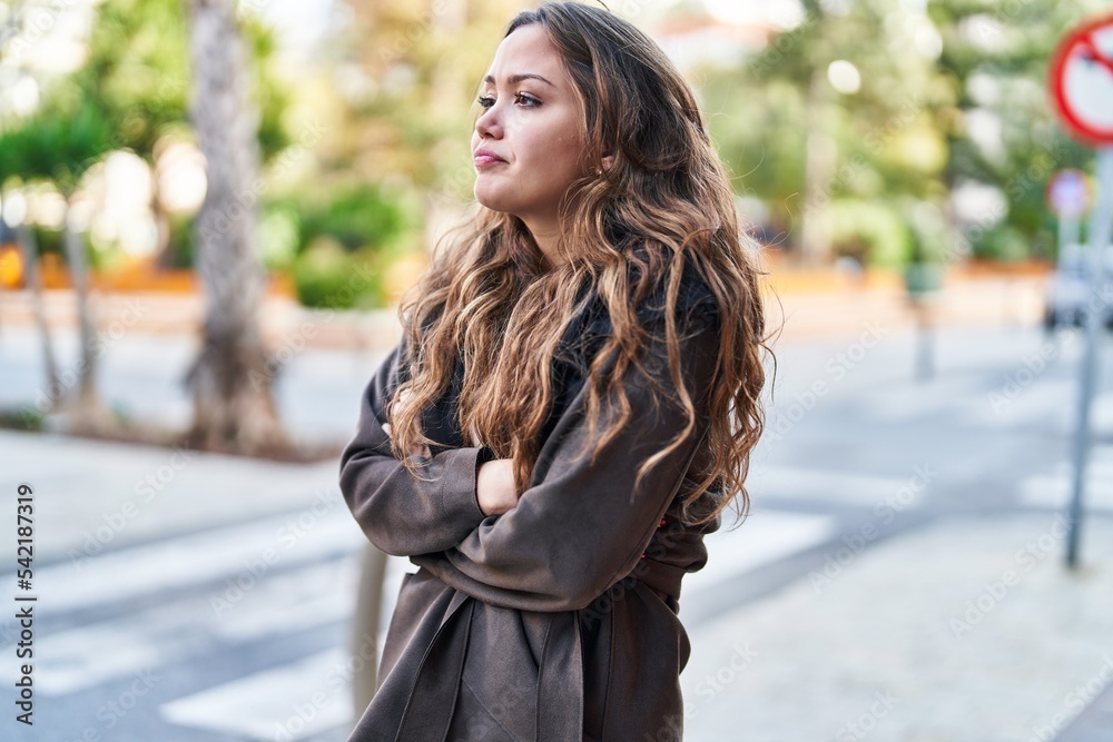 Young beautiful hispanic woman standing with arms crossed gesture at street Young beautiful hispanic woman standing with arms crossed gesture at street