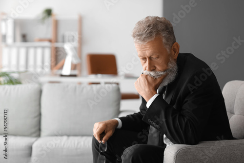 Thoughtful mature man sitti...