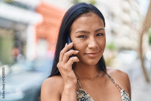 Young beautiful latin woman smiling confident talking on the smartphone at street