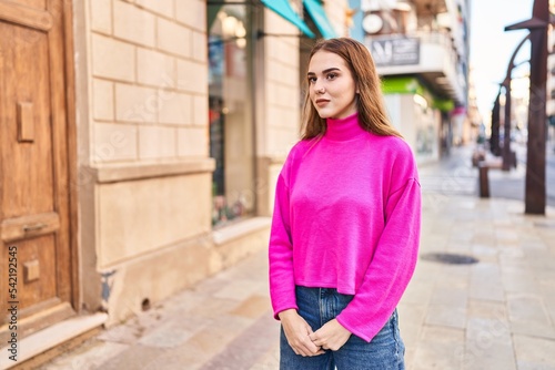 Young woman with relaxed expression standing at street