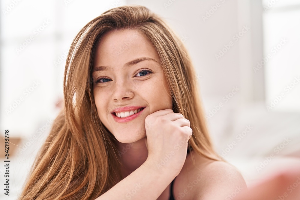 Young caucasian woman smiling confident sitting on bed at bedroom Young caucasian woman smiling confident sitting on bed at bedroom