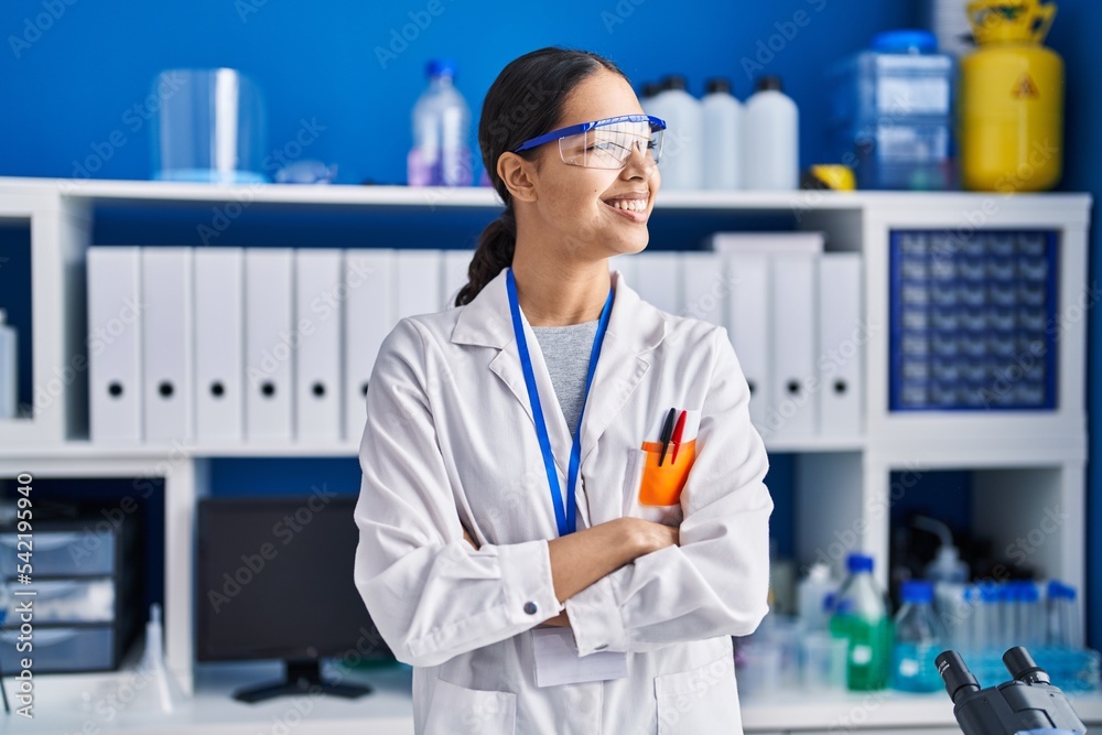Young african american woman scientist standing with arms crossed gesture at laboratory Young african american woman scientist standing with arms crossed gesture at laboratory