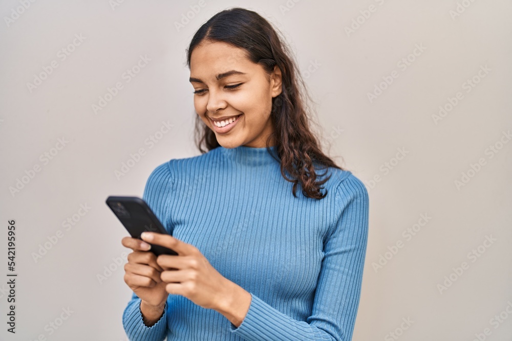 Young african american woman smiling confident using smartphone over isolated white background Young african american woman smiling confident using smartphone over isolated white background