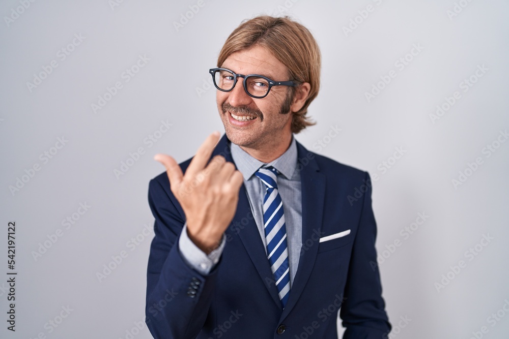 Caucasian man with mustache wearing business clothes beckoning come here gesture with hand inviting welcoming happy and smiling Caucasian man with mustache wearing business clothes beckoning come here gesture with hand inviting welcoming happy and smiling