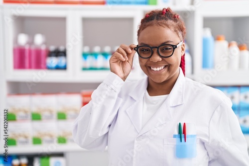 African american woman pharmacist smiling confident standing at pharmacy