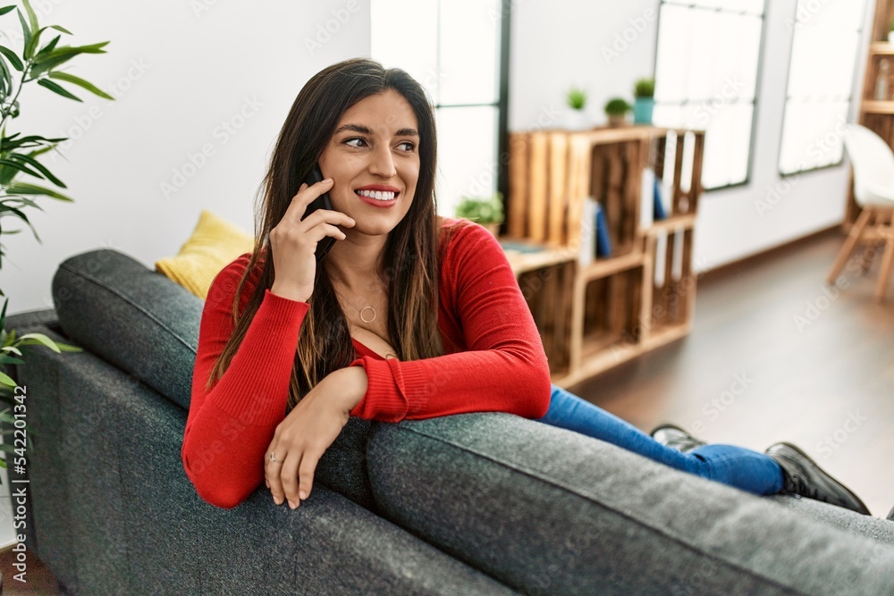 Young woman smiling confident talking on the smartphone at home Young woman smiling confident talking on the smartphone at home