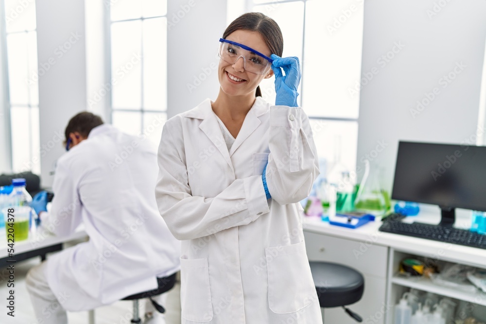 Man and woman partners wearing scientist uniform working at laboratory Man and woman partners wearing scientist uniform working at laboratory
