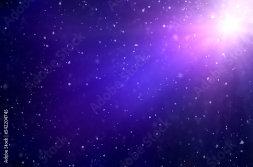 Snow falling in rays of single light glare on deep blue sapphire color night sky. Winter blur empty background.
