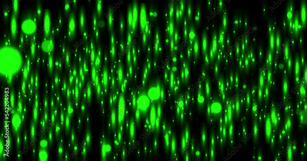 Slowly flying green abstract particles on a black background. Luminous vertically elongated bokeh particles. Slowly flying green abstract particles on a black background. Luminous vertically elongated bokeh particles.