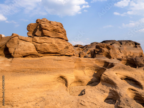 The big sandstone and blue sky famous place in Thailand is called Sam phan bok.