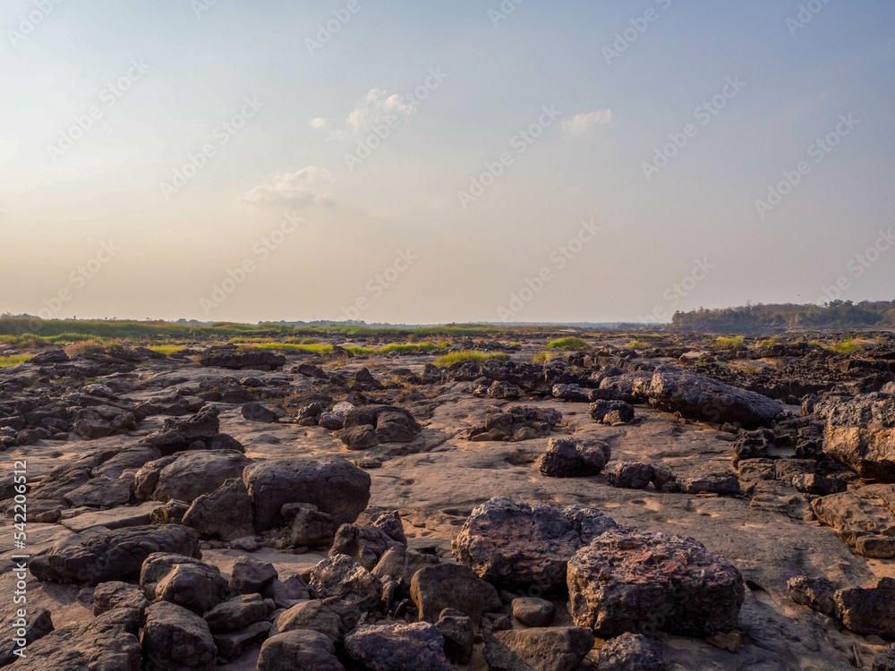 The big stone in the rocky shore in the middle of the Mekong river.