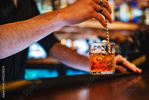 man bartender hand making negroni cocktail