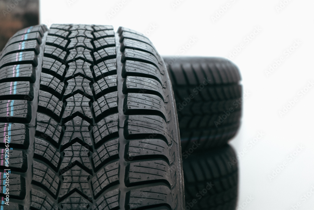 Stack car wheel winter tires isolated. New tyres. Place for text