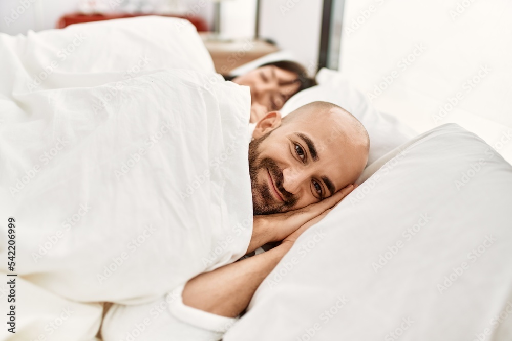 Young hispanic couple sleeping on the bed at bedroom. Young hispanic couple sleeping on the bed at bedroom.