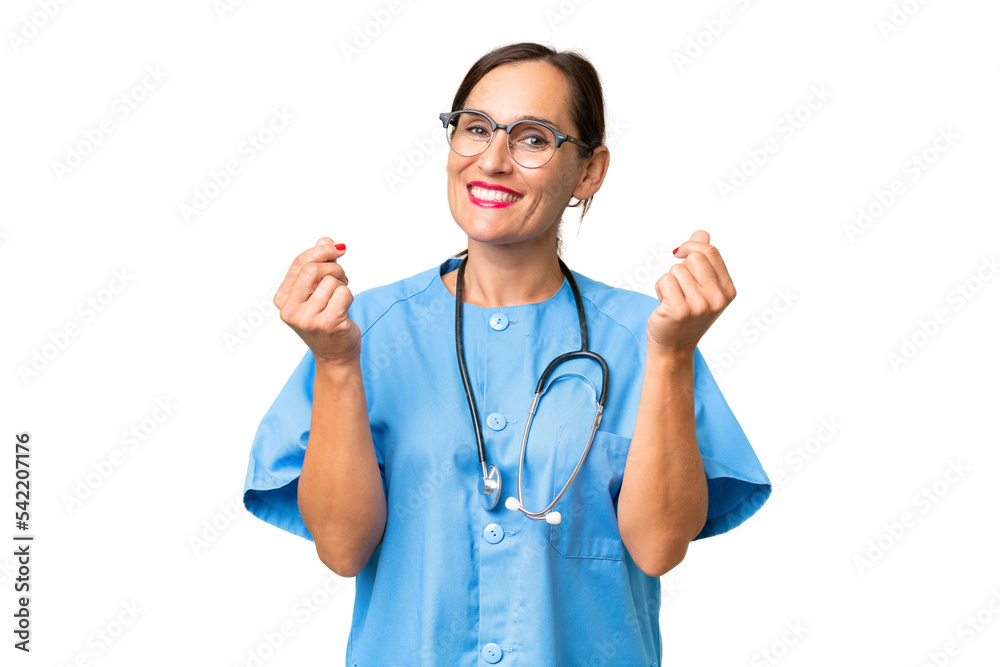 Middle-aged nurse woman over isolated background making money gesture