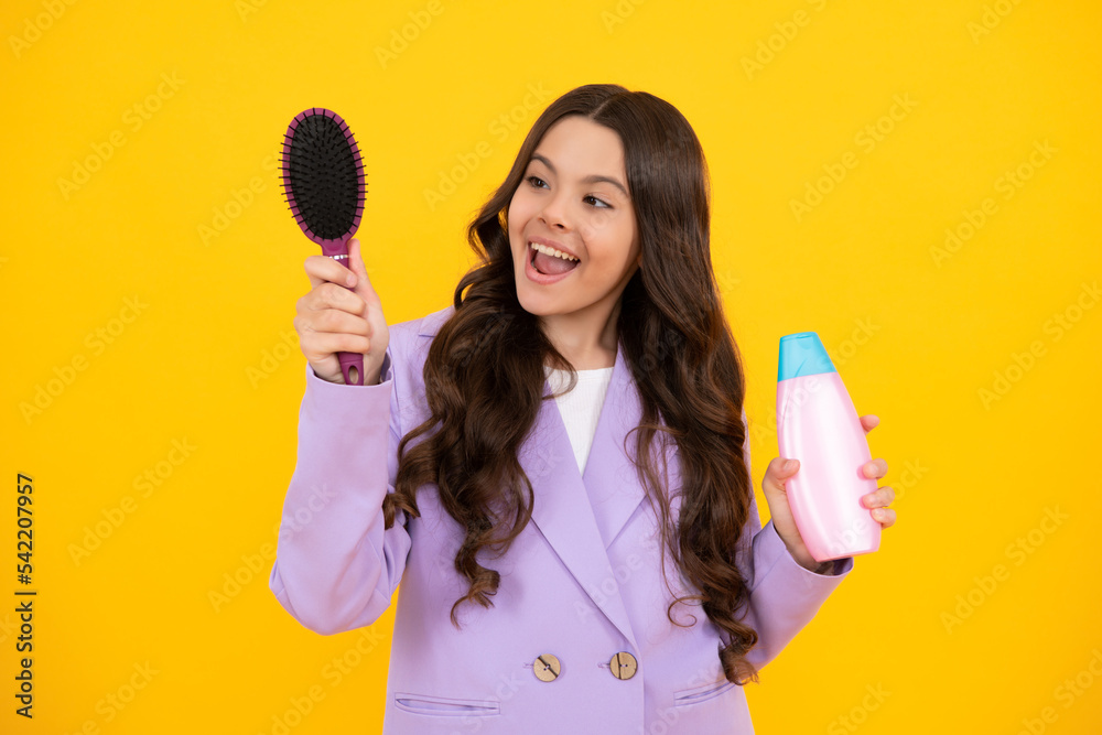 Child with shampoo conditioner. Daily cosmetic care. Teenager kid 12, 13, 14 years old hold bottle of hair and skin care. Beauty health and cosmetics. Happy face, positive and smiling. Child with shampoo conditioner. Daily cosmetic care. Teenager kid 12, 13, 14 years old hold bottle of hair and skin care. Beauty health and cosmetics. Happy face, positive and smiling.