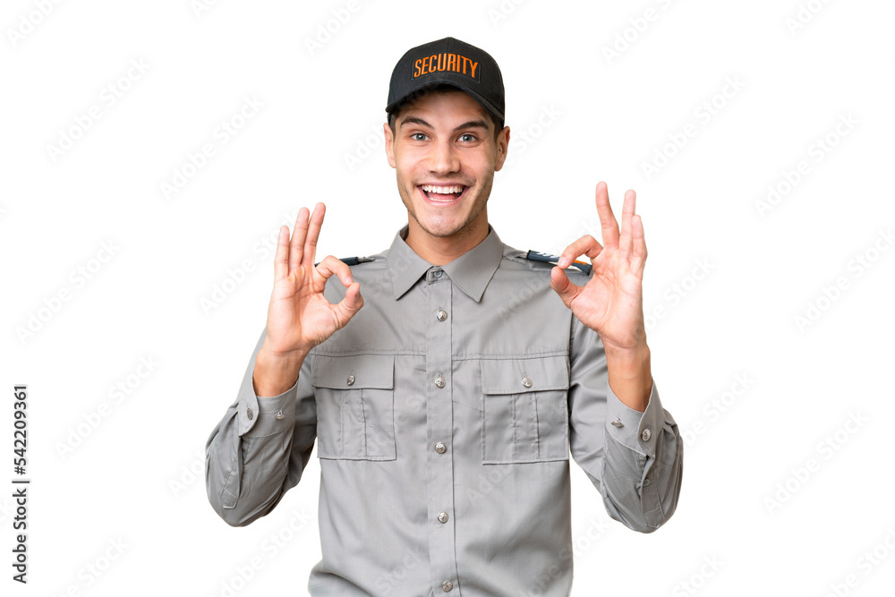 Young security man over isolated background showing an ok sign with fingers