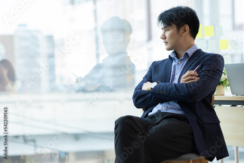 Portrait of a handsome businessman looking and thinking.