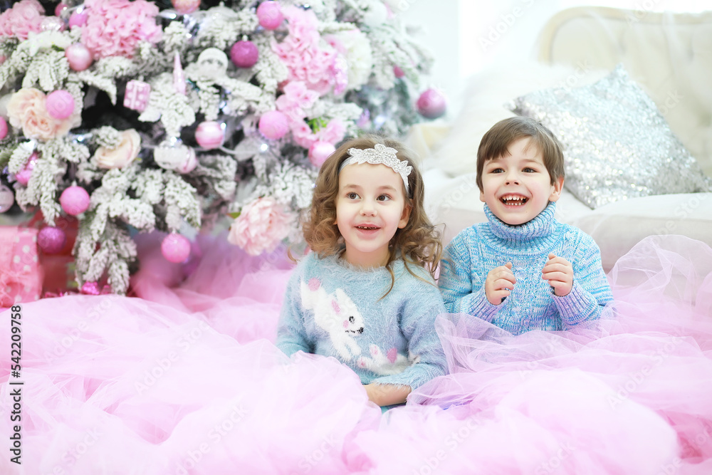 Family decorating beautiful live Christmas tree. Loving family with presents in room. Happy family on holidays. Family decorating beautiful live Christmas tree. Loving family with presents in room. Happy family on holidays.