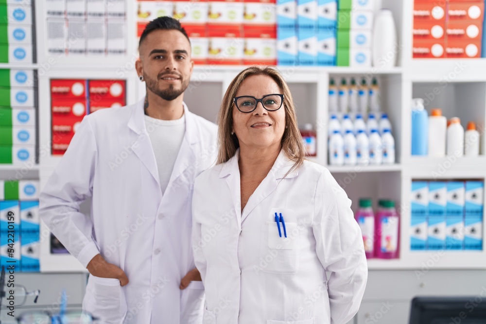 Man and woman pharmacist smiling confident standing at pharmacy Man and woman pharmacist smiling confident standing at pharmacy