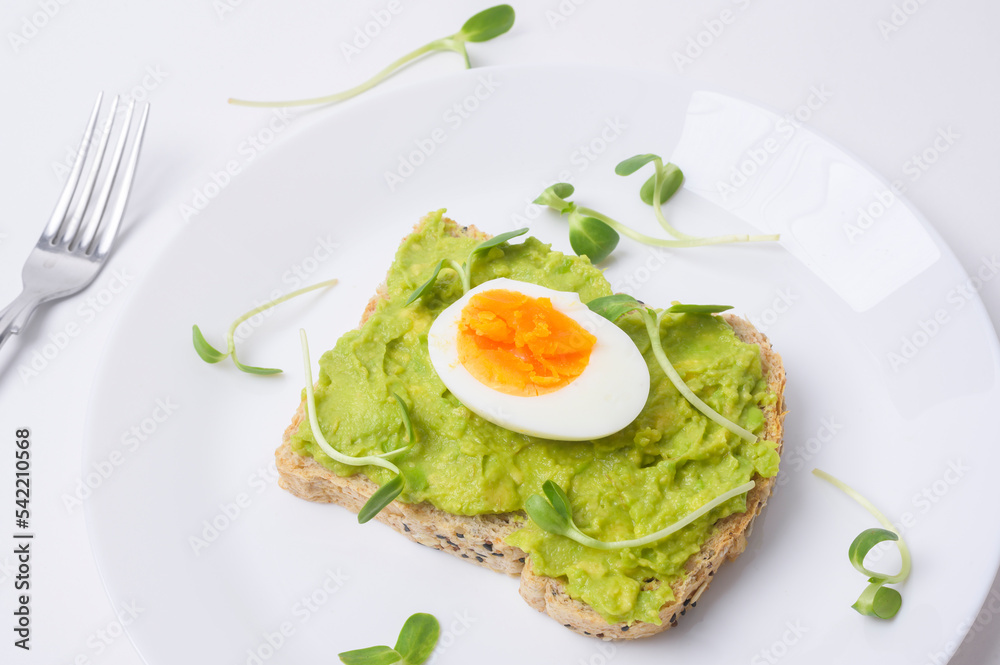 Bread with avocado , vegetables fruit and egg on white background , Healthy breakfast concept