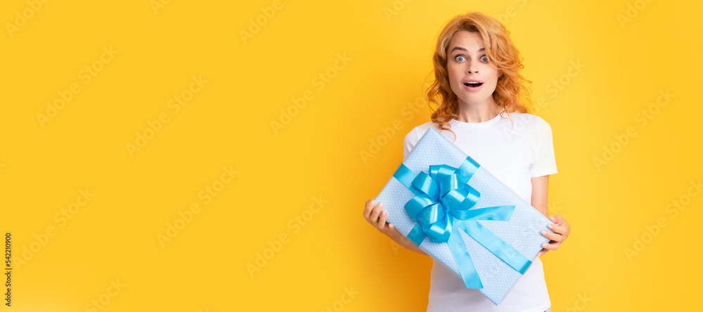 surprised redhead girl with gift box. boxing day. Beauty woman isolated face portrait, banner with mock up copy space.