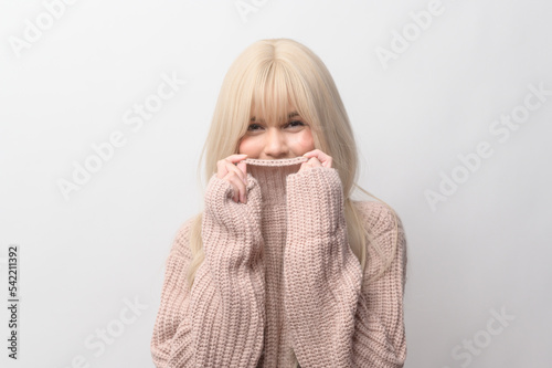 Portrait of Caucasian young woman wearing sweater over white background © tonefotografia