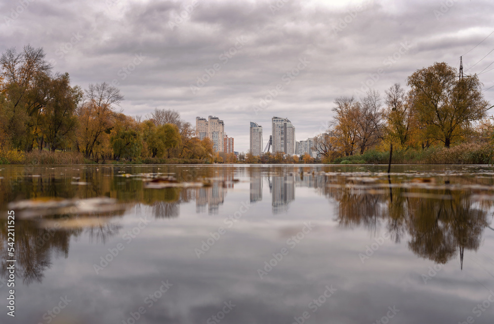 Verbne lake in Obolon in Kyiv: cloudy autumn day and reflection in the water