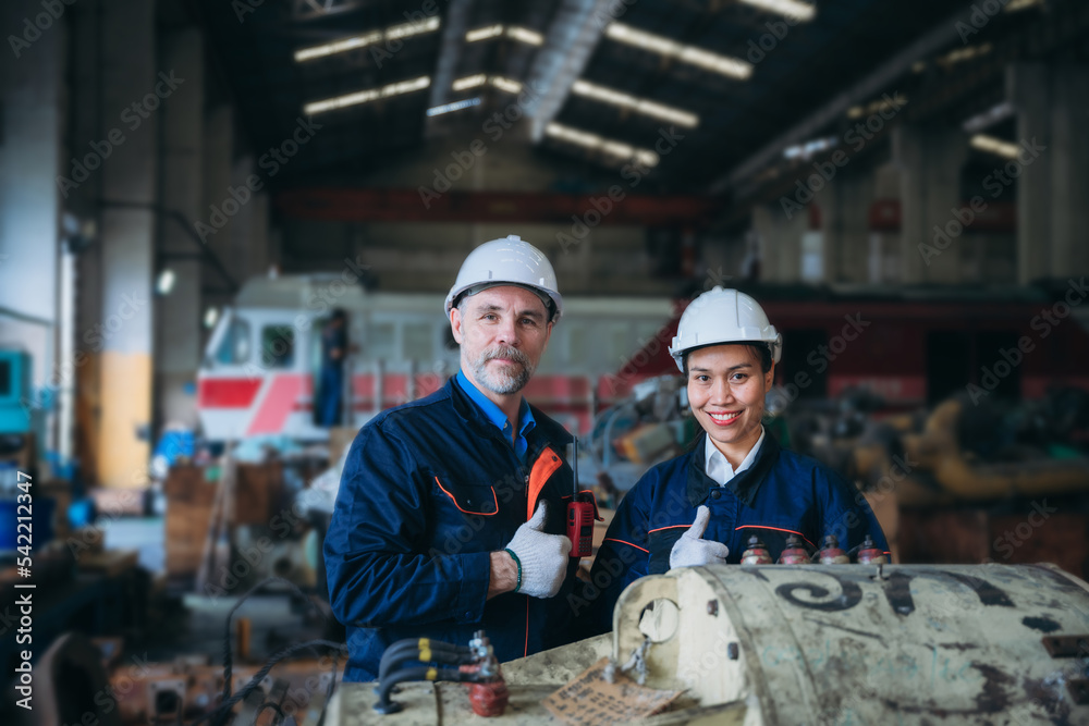 Portrait of Professional Engineers express a high level of confidence at the railway garage. Portrait of Professional Engineers express a high level of confidence at the railway garage.