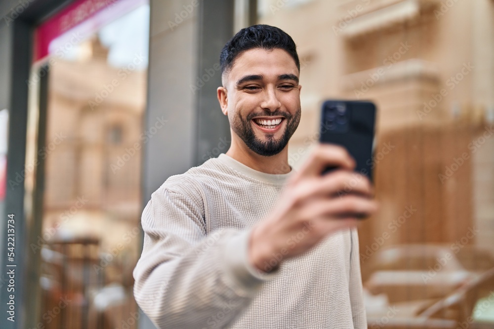 Young arab man smiling confident using smartphone at street Young arab man smiling confident using smartphone at street